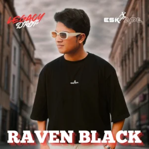 A man wearing a black oversized t-shirt labeled "Raven Black" from the "Legacy Drop" collection by Eskape, styled with white-framed sunglasses, posing in an urban street setting.